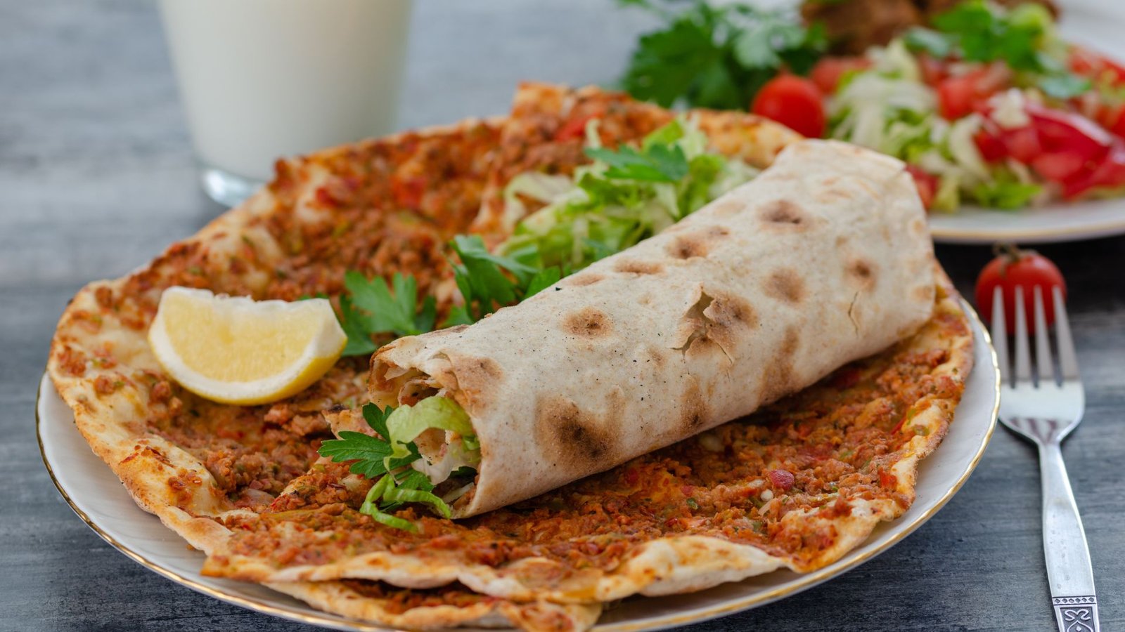 Turkish lahmacun with fresh herbs and lemon